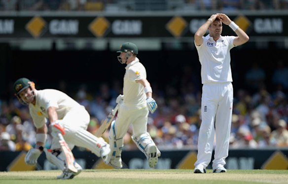 James Anderson of England reacts as Michael Clarke and David Warner of Australia score runs.