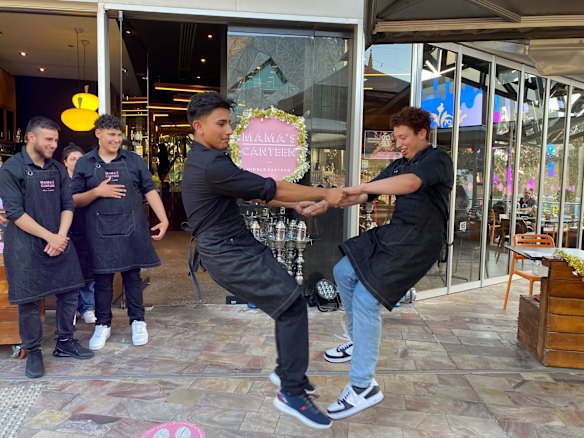 Staff at Mama’s canteen dancing as they prepare for their customers on New Years Eve. 