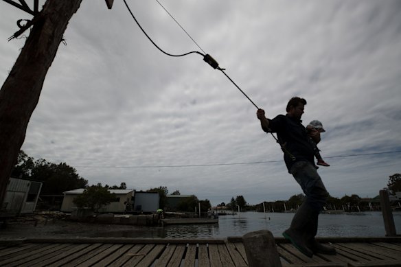 Oyster farmer, Ewan McAsh with his eight-month-old daughter, Ivy.