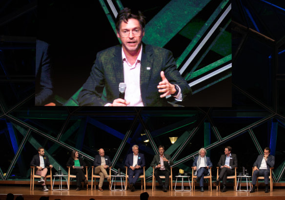 Nick Reece takes the microphone during a debate with City of Melbourne mayoral candidates. Arron Wood is fourth from left.