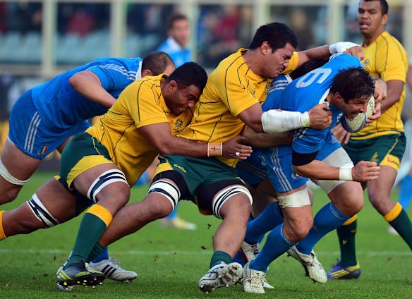 Italy's flanker Alessandro Zanni  is tackled by Wycliff Palu and Sitaleki Timani.