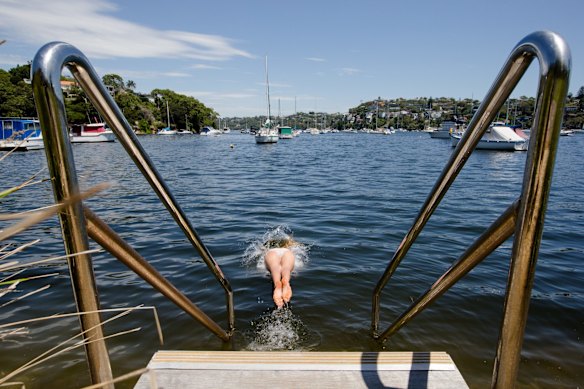People cool off in the water at The Spit, Pearl Bay.