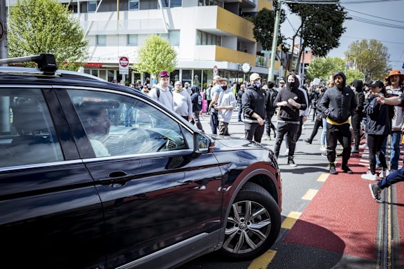 A lady in a vehicle bursts into tears as anti-lockdown protesters stop traffic in Richmond.