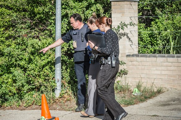 Police officers and forensic staff attend the scene of an overnight shooting and arson attack in Harrington circuit, Kambah. Numerous bullets have hit the home and three vehicles have been set alight. 