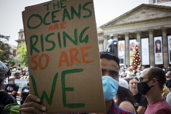 A Climate Change activists communicates his message near the steps of the State Library today, before the group marchied through the CBD.