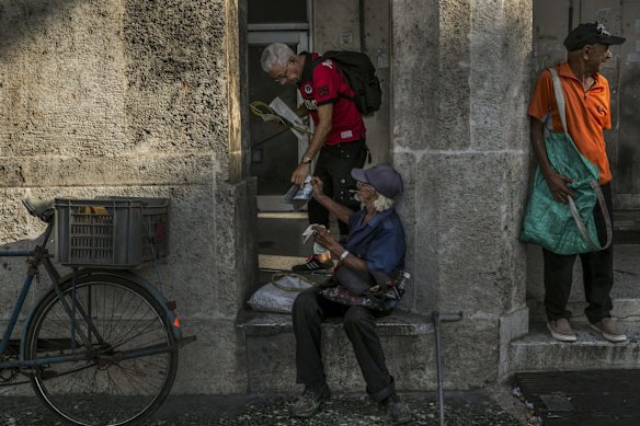 A vendor sells a newspaper on the day of President Barack Obama's arrival for an official visit to Cuba.
