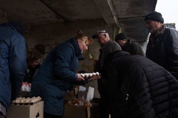 Volunteers give food to local residents in Svitylnia, Ukraine.