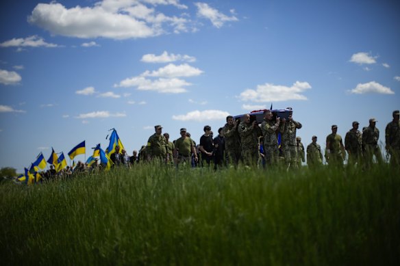 Ukrainian soldiers carry the coffin of Volodymyr Losev, 38, during his funeral in Zorya Truda.