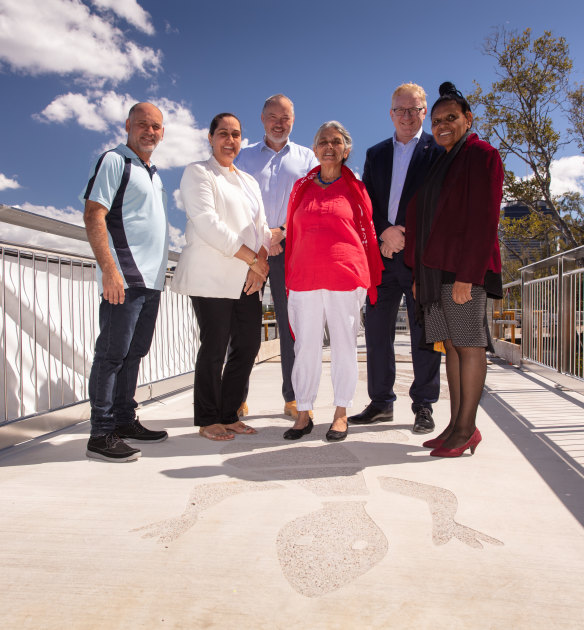 Aboriginal representatives James Bonner, Madonna Thomson, Simon Crook (Destination Brisbane), art consultant Vanessa Fisher, Destination Brisbane chief executive Geoff Hogg and Turrbal people's Maroochy Barambah with a sand goanna totem.