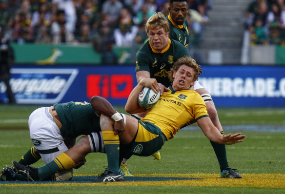 Australia's Ned Hanigan, front right, is tackled by South Africa's Pieter-Steph du Toit.