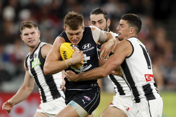 Cripps is tackled against Collingwood.