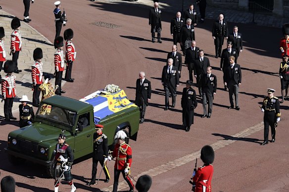 Family members follow the coffin aboard the Land Rover designed by Prince Philip himself.