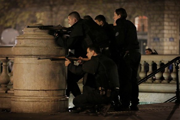 Police with weapons draw react to suspcious behavoir at Place de la Republique in Paris.