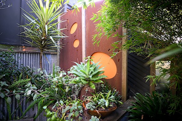 Wells pairs weathered surfaces with textured plantings.