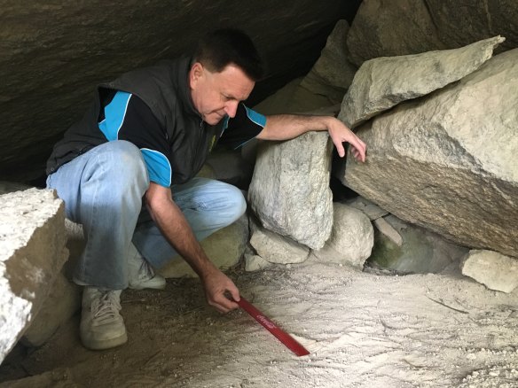 Greg Shaw measures the mystery left footprint with a ruler.