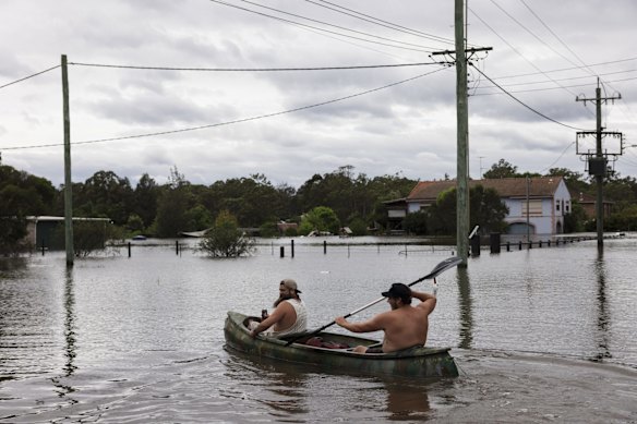 Steve Nicholson and Josh Richardson paddle out onto Eldon Street in Pitt Town.