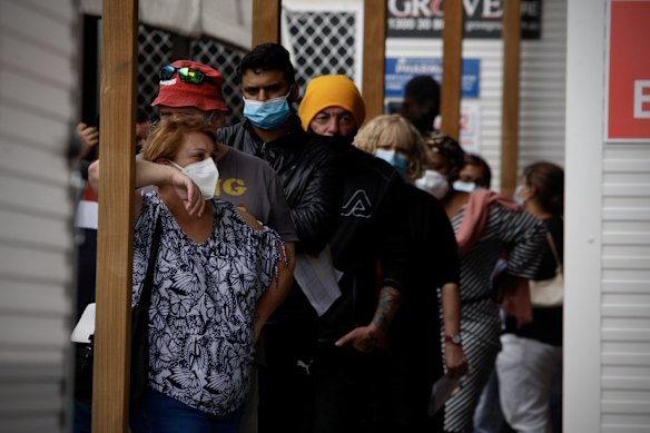 People queue at the Kildare Road Medical Centre in Blacktown for a COVID PCR test.