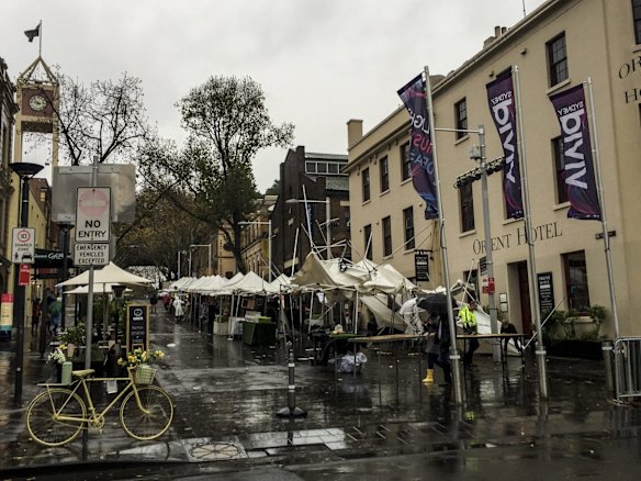 Wet weather and winds cause havoc at the markets in The Rocks, Sydney. 