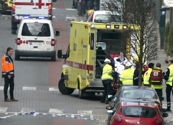 A woman is evacuated in an ambulance by emergency services after a explosion in a main metro station in Brussels.