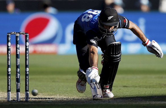 New Zealand's Grant Elliott reaches to make his ground during the Cricket World Cup final match against Australia at the Melbourne Cricket Ground (MCG) March 29, 2015.    