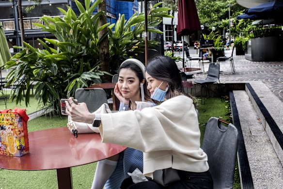 Girls taking pictures in a newer area of Chinatown, Sydney.