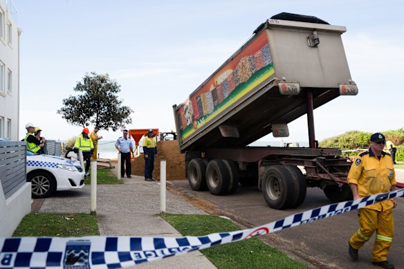 Sand is delivered for a sandbagging operation to try and protect storm damaged residences at Collaroy.