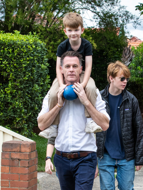 “At the moment [at] many schools across New South Wales, kids are on their mobile devices right through recess and lunchtime,” says NSW Premier Chris Minns, pictured in Sydney earlier this month with two of his three sons.