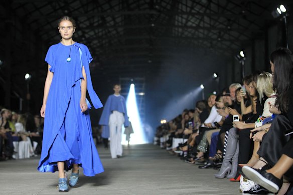 Models walk the catwalk as the audience get's their phone camera's ready.