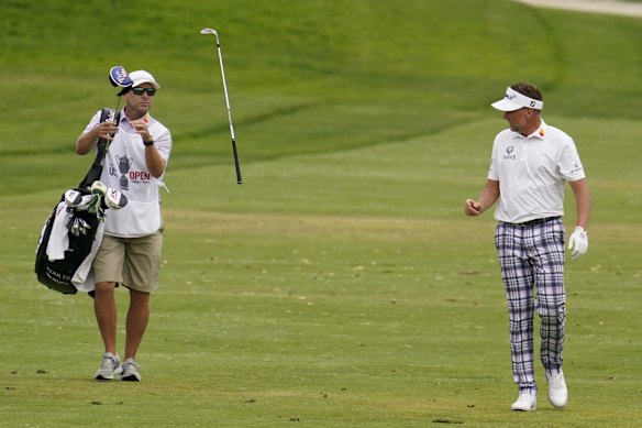 Ian Poulter throws his club to his caddy as they walk up the 18th fairway at the 2021 US Open at Torrey Pines.