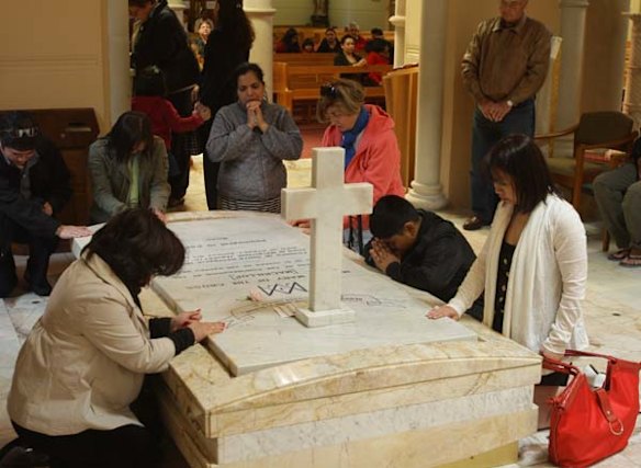 People pray at Mary MacKillop's tomb in The Mary MacKillop Memorial Chapel on the eve of her canonisation to become a saint. 