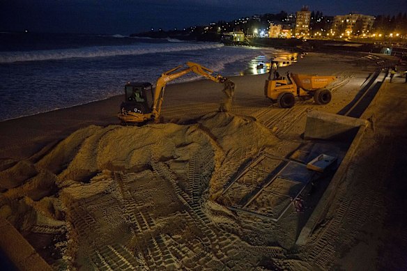 Coogee Beach - 4 hours before high tide and the water is up very high as they try to clear sand from the Surf Lifesavers boat shed on June 6th.