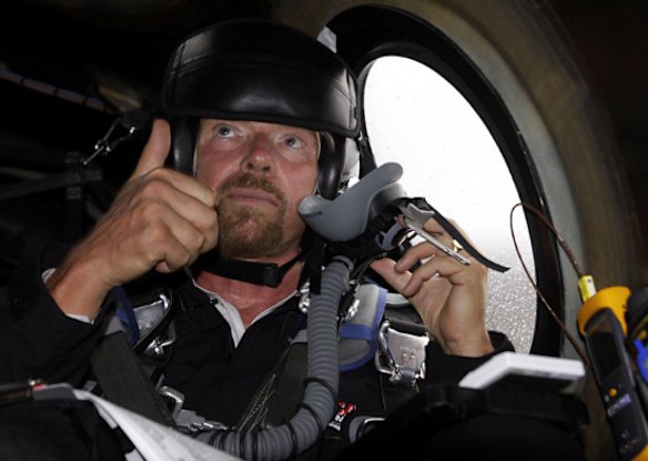 Richard Branson gives a thumbs up as he gets pre-flight instructions in preparation to fly on WhiteKnightTwo.