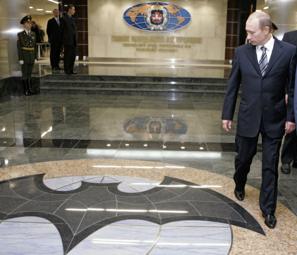 Russian President Vladimir Putin, right, walks through a hall in the building of the Main Directorate of the General Staff of the Armed Forces of Russia, also know as Russian military intelligence service in Moscow, in 2006.