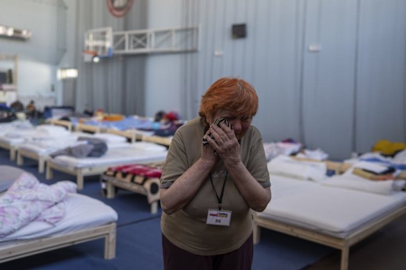Zinaida Pivtsova, 75, who fled the war in Ukraine, wipes away her tears inside a sports stadium of a high school in Przemysl, in south-east Poland, where refugees take shelter.
