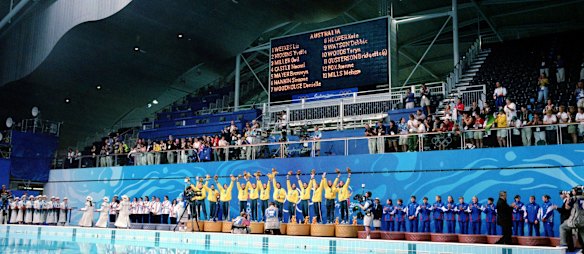 The Australian women's water polo team receive their gold medals.