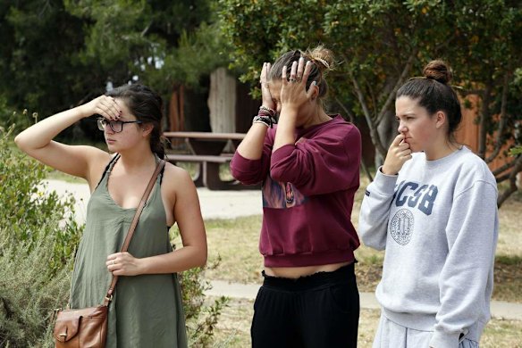 UC Santa Barbara students react near one of the crime scenes after series of drive-by shootings in the Isla Vista section of Santa Barbara.