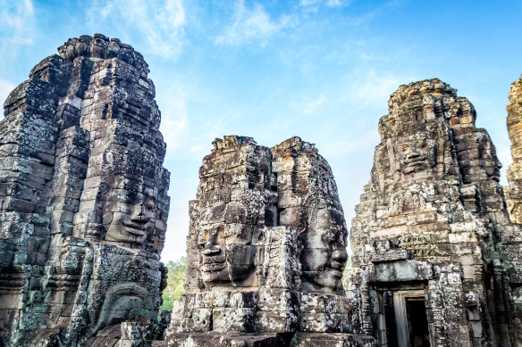 The towers of the Bayon temple are covered in over 200 huge smiling stone faces. The temple forms part of the Angkor complex at Siem Reap.