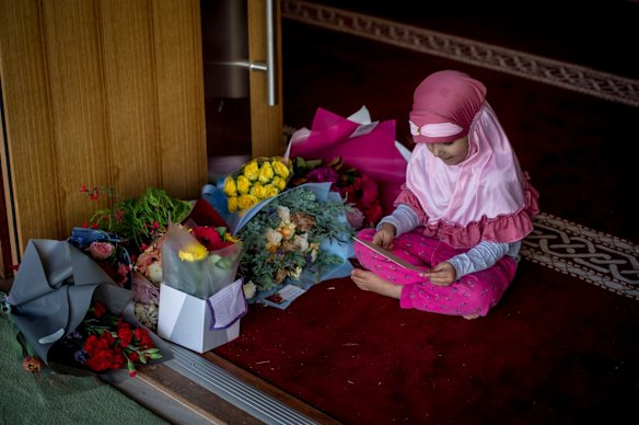 Alishiba Jadoon, 4 checks out the flowers and well wishes left by the Canberra community in support of their Muslim neighbours. 