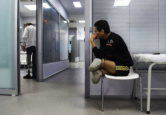 Abdalrahman from Mosul in Iraq, aged 18 years (right) who lost both legs in a coalition airstrike watches Najm Eddin Najm Alden, from Aleppo in Syria, aged 50 years old (left) try out his new prosthetic leg in the Kuwait Istanbul Orthotic-Prosthetic Center in Istanbul. The Kuwait Istanbul Orthotic-Prosthetic Center provides Syrian refugees who have lost limbs in the Syrian war with free prosthetics that they make with high-tech scanners. The patients also receive ongoing medical treatment and physiotherapy. 