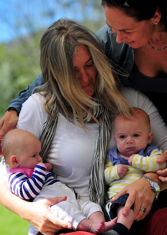 Canberra Capitals coach Carrie Graf, with partner Camille Chicheportische and baby twins Bentley (blue and yellow top) and Charli (blue and pink top).