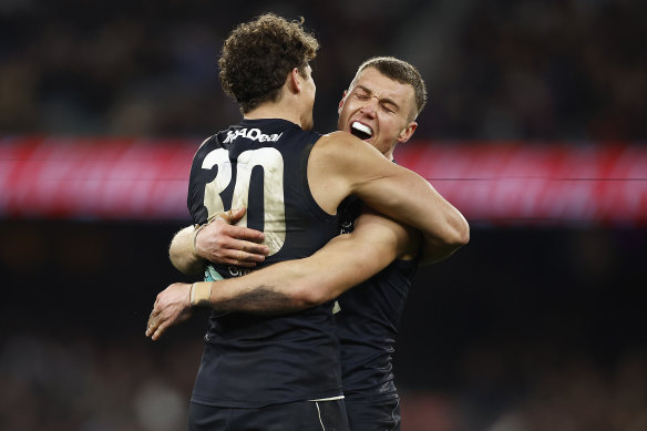 Finals bound: Charlie Curnow and Patrick Cripps celebrate winning a thriller at the MCG.