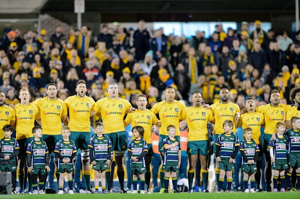 Wallabies players sing the Australian national anthem. 