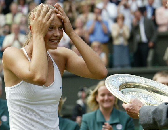 Breakthrough win: Russia's Maria Sharapova receives the Wimbledon winner's trophy after defeating Serena Williams in 2004.