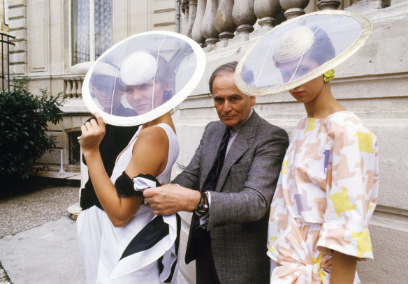 In this 1984 file photo, Cardin and models wearing ensembles from the summer 1985 ready-to-wear Cardin collection pose in Paris. 