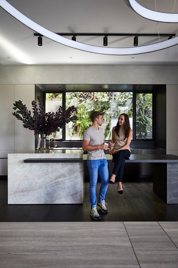 Janine and Riley in the kitchen. “The bench is made of virtually indestructible Dekton from Cosentino – Penny and I tested it with a jackhammer,” she says. 