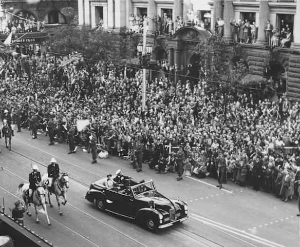 Huge crowds gathered to watch the Queen and Prince Philip as they parade along Swanston Street past the Melbourne Town Hall during the 1954 Royal Visit to Australia.