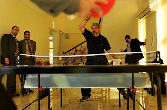 Khalid Mishal (2nd from right) plays table tennis with a friend at a private residential gym in Doha, Qatar.