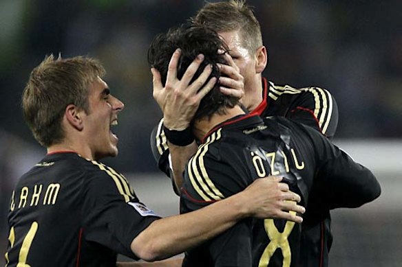 Germany's Mesut Ozil, is congratulated by teammates Philipp Lahm, left, and Bastian Schweinsteiger.