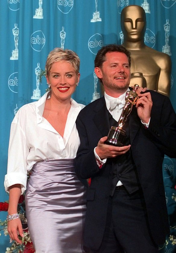 Sharon Stone, 1998 Academy Awards, Gap shirt and Vera Wang skirt. 'Sharon Stone’s look is the perfect example of mixing high and low. The crisp white, almost men’s shirt, paired with the beautiful satin Vera Wang evening skirt makes her look effortless yet sophisticated. And having the shirt open adds that touch of sexiness to this all-American look.'
