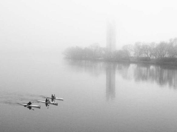 Carillon Kayaks: 3 kayaks rowing in front of the Carillon on a foggy Sunday morning.